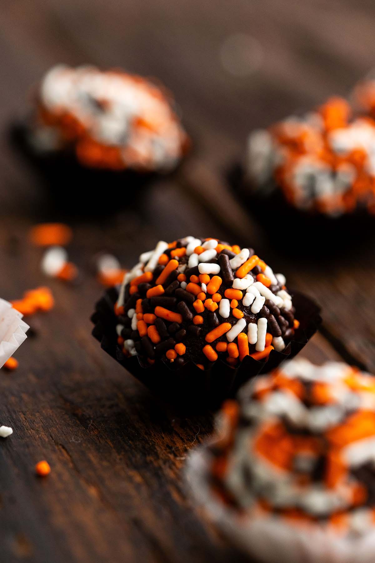 easy pumpkin truffles with halloween sprinkles on wooden table