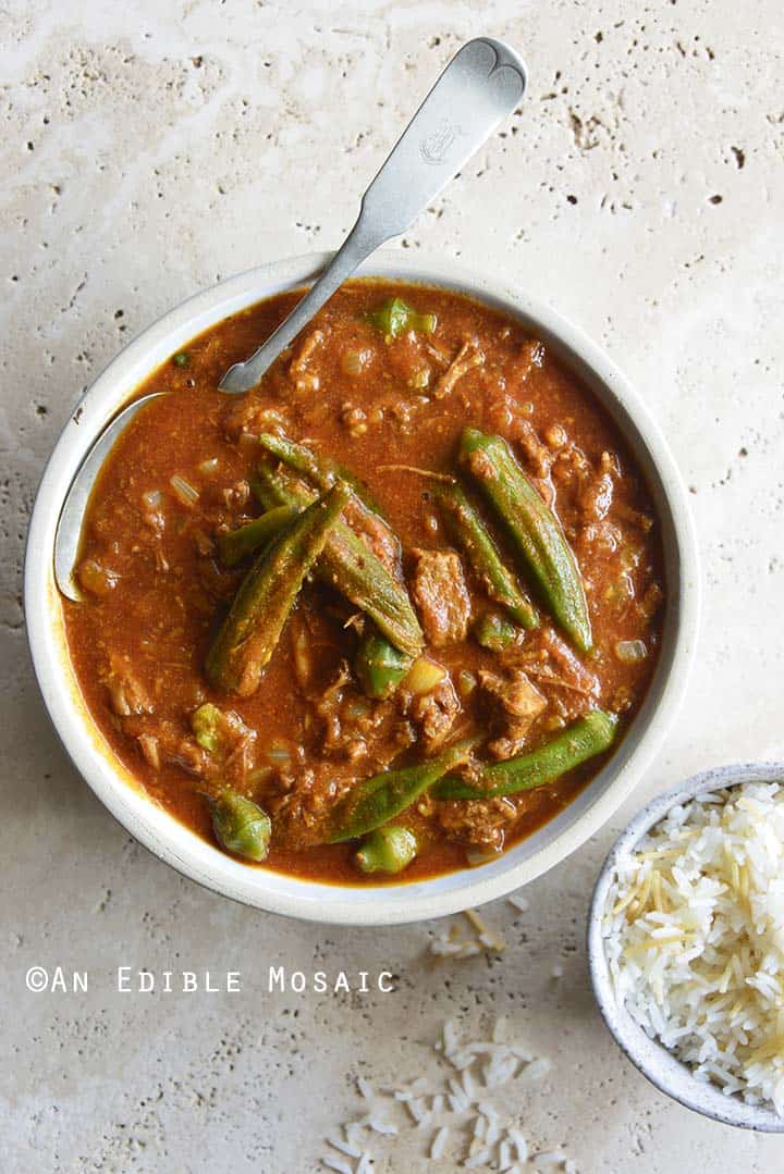 Stoneware Bowl of Persian Okra Stew (Khoresh Bamieh) with Small Dish of Rice