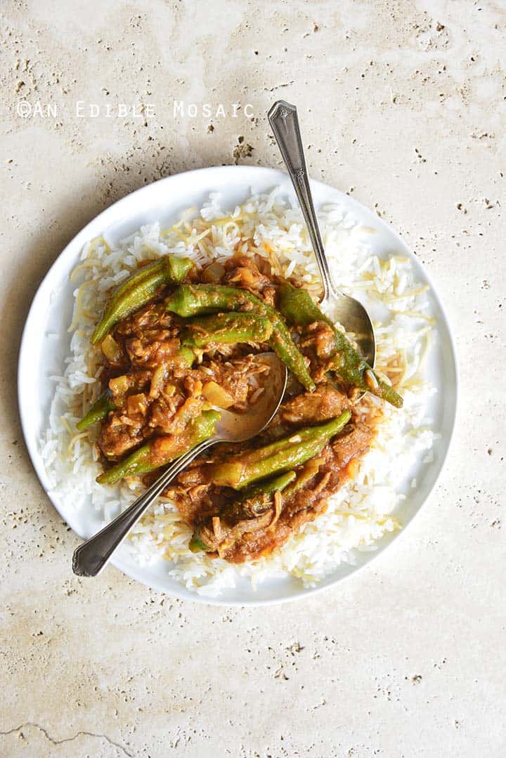 White Plate with Persian Okra Stew (Khoresh Bamieh) on Concrete Background