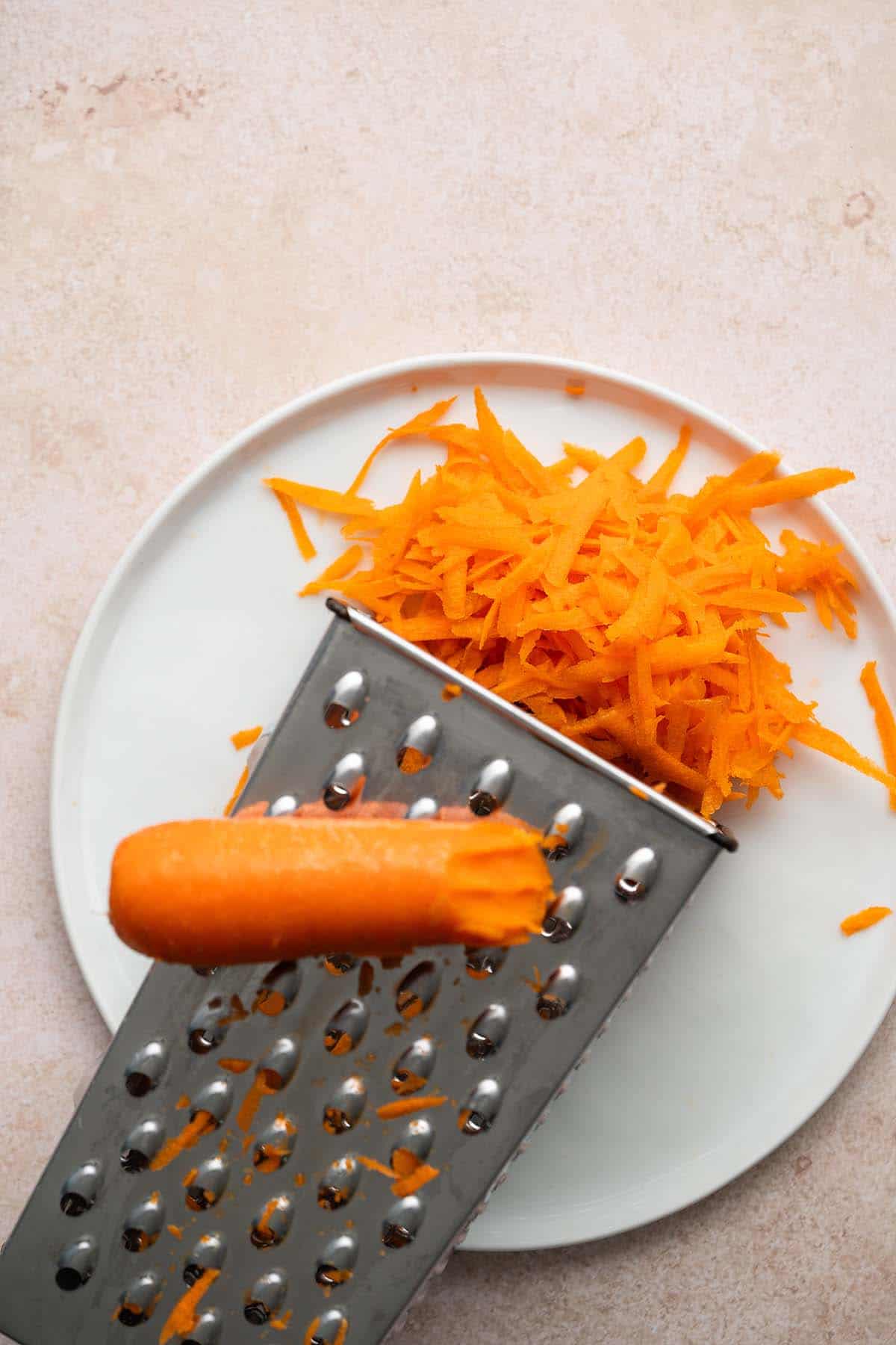 shredding carrot on box grater