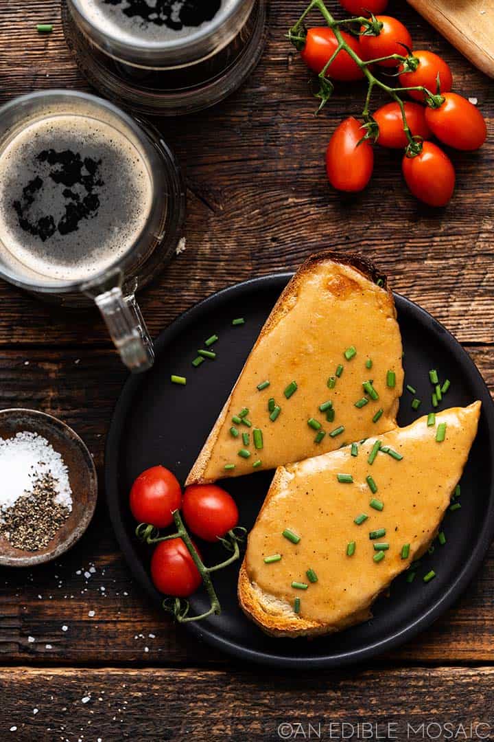 overhead view of welsh cheese toast on dark wooden table