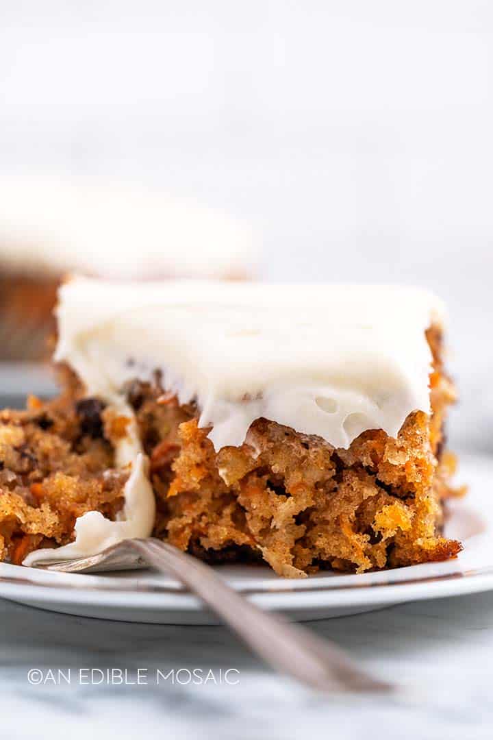 close up front view of carrot cake slice on plate