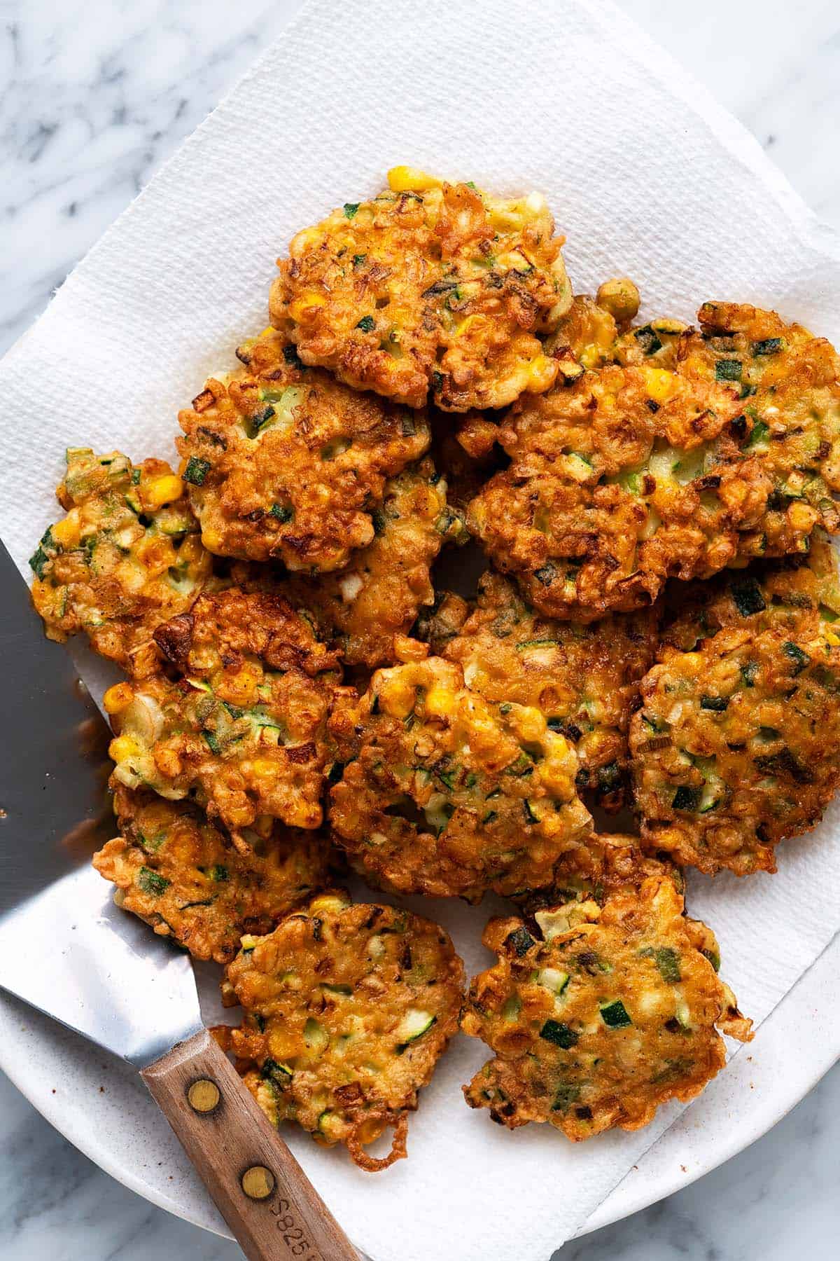 drain fried vegetable fritters on paper towels