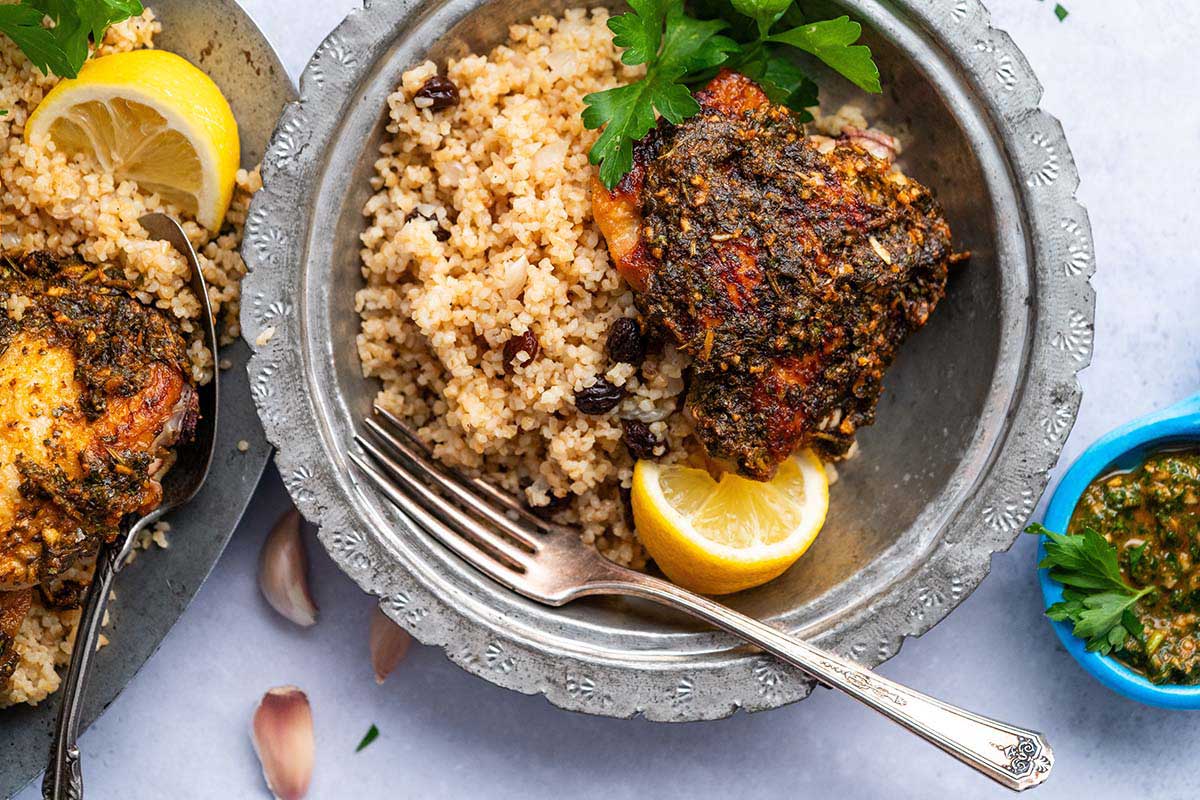 close up top view of chermoula chicken with sauce served with pilav