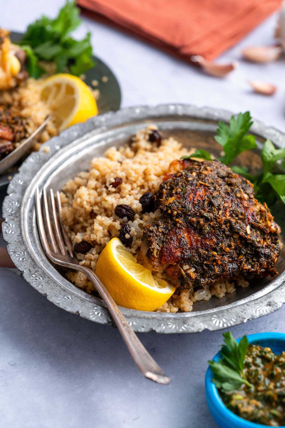 front view of bowl of jeweled pilaf with Chermoula chicken