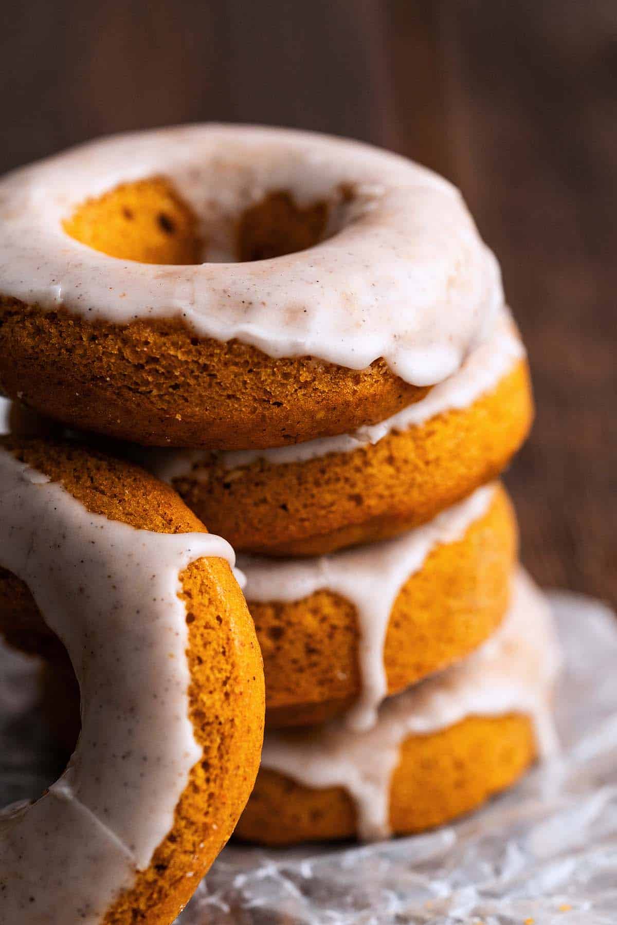 stack of baked pumpkin doughnuts on wax paper