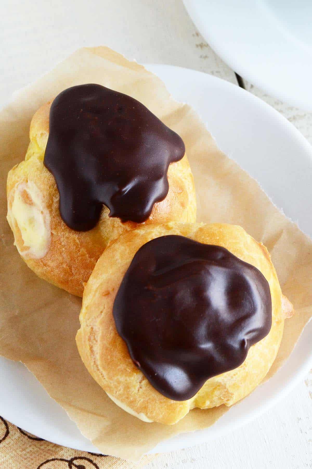 close up of custard profiteroles on plate