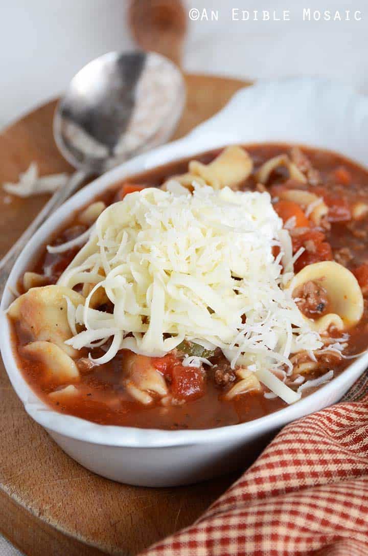 Close Up Front View of Lasagna Soup in White Dish with Red Linen