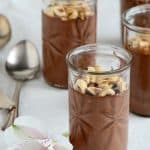 Chocolate-Hazelnut Custard on a White Fabric with an Exotic Flower Front View Vertical Orientation