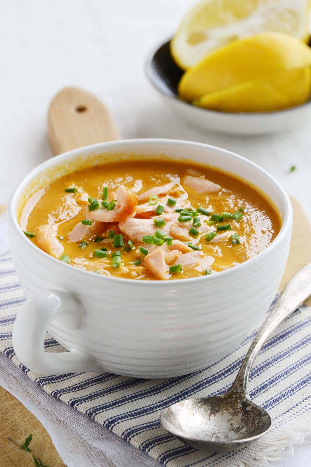 close up front view of the best salmon bisque in a white mug