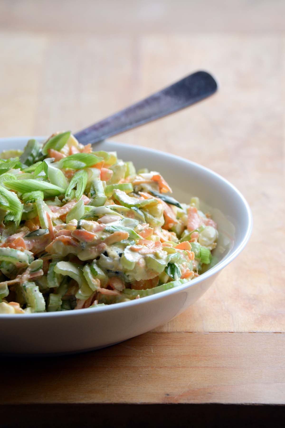 front view of bowl of celery blue cheese slaw for topping buffalo chicken burgers