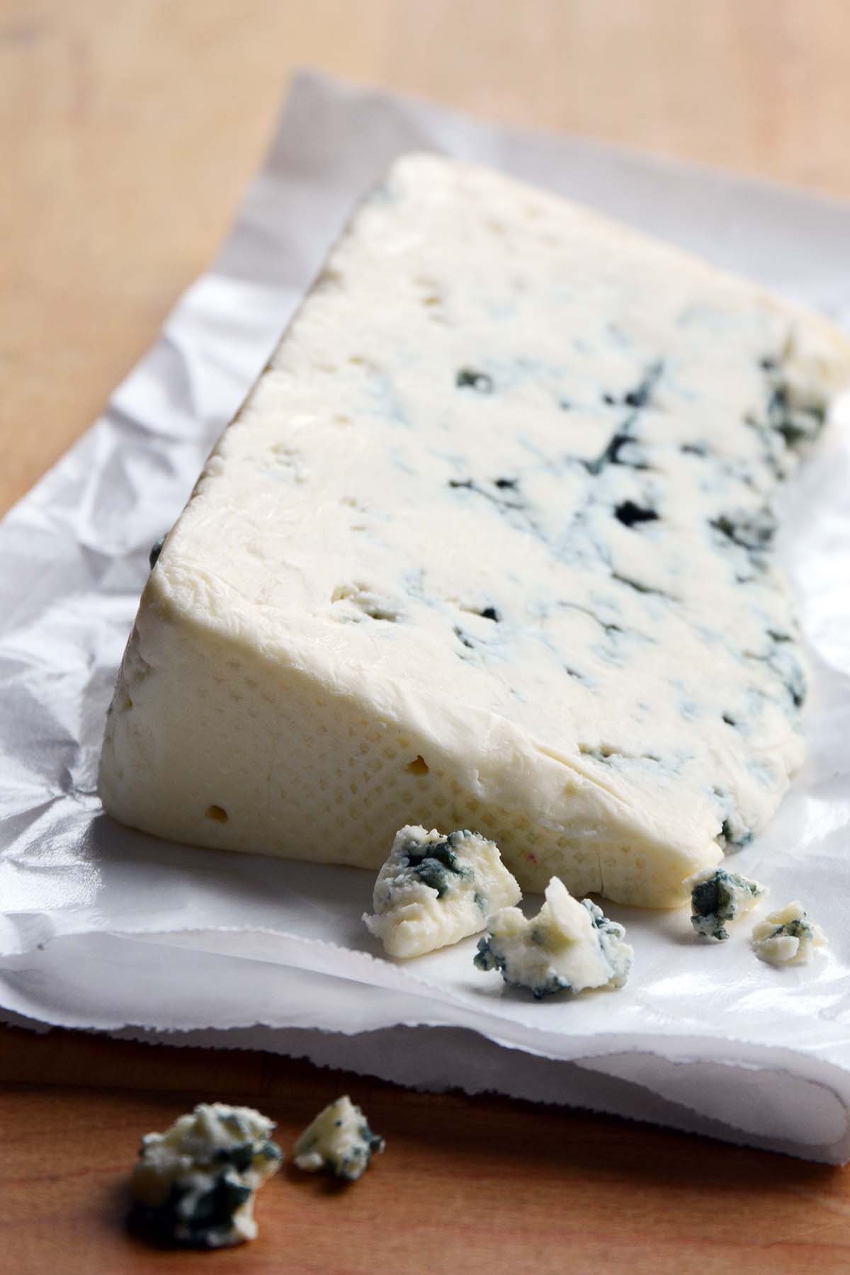 wedge of blue cheese on cheese paper