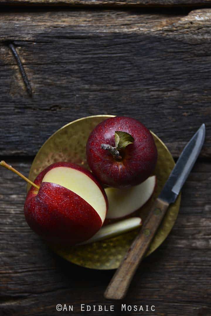 Fresh Apples on Golden Plate on Dark Wooden Table