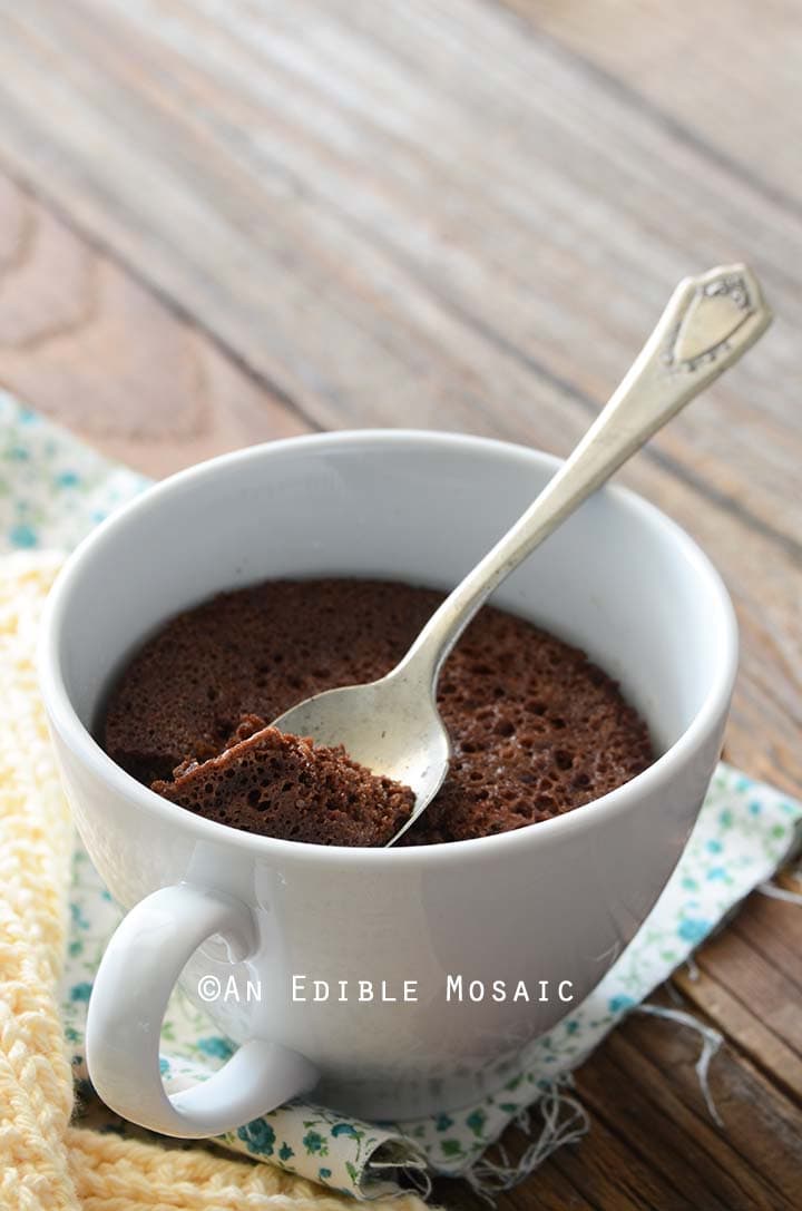 Healthy Chocolate Mug Cake Recipe in White Mug on Wooden Table