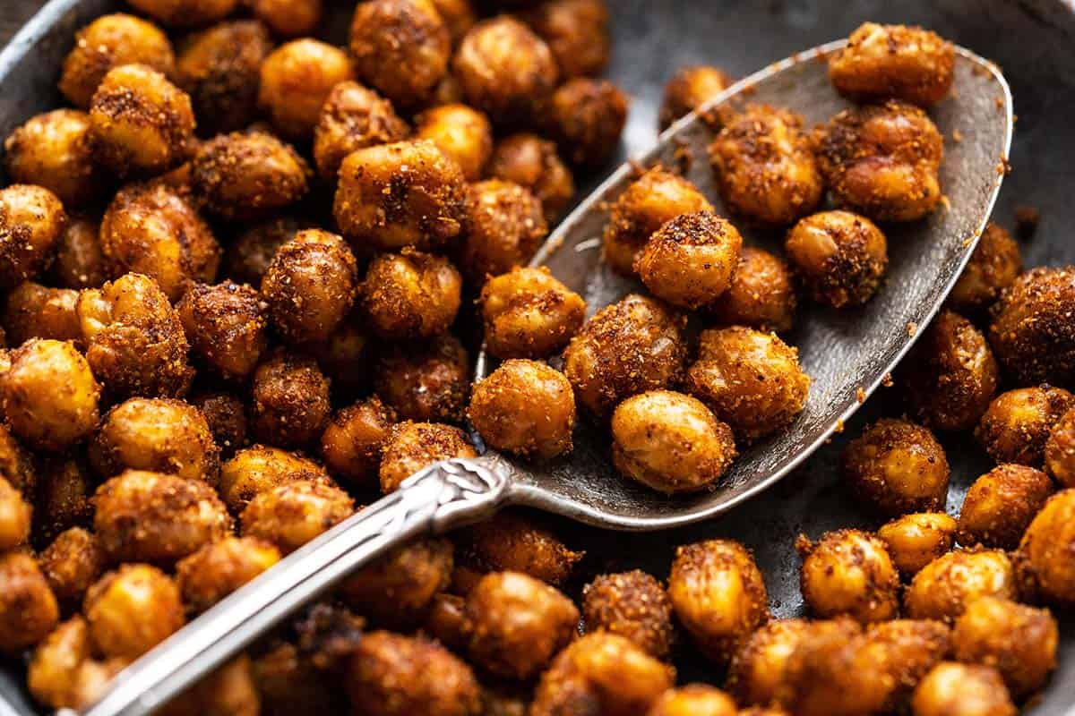 close up of healthy oven roasted chickpeas in silver dish with spoon