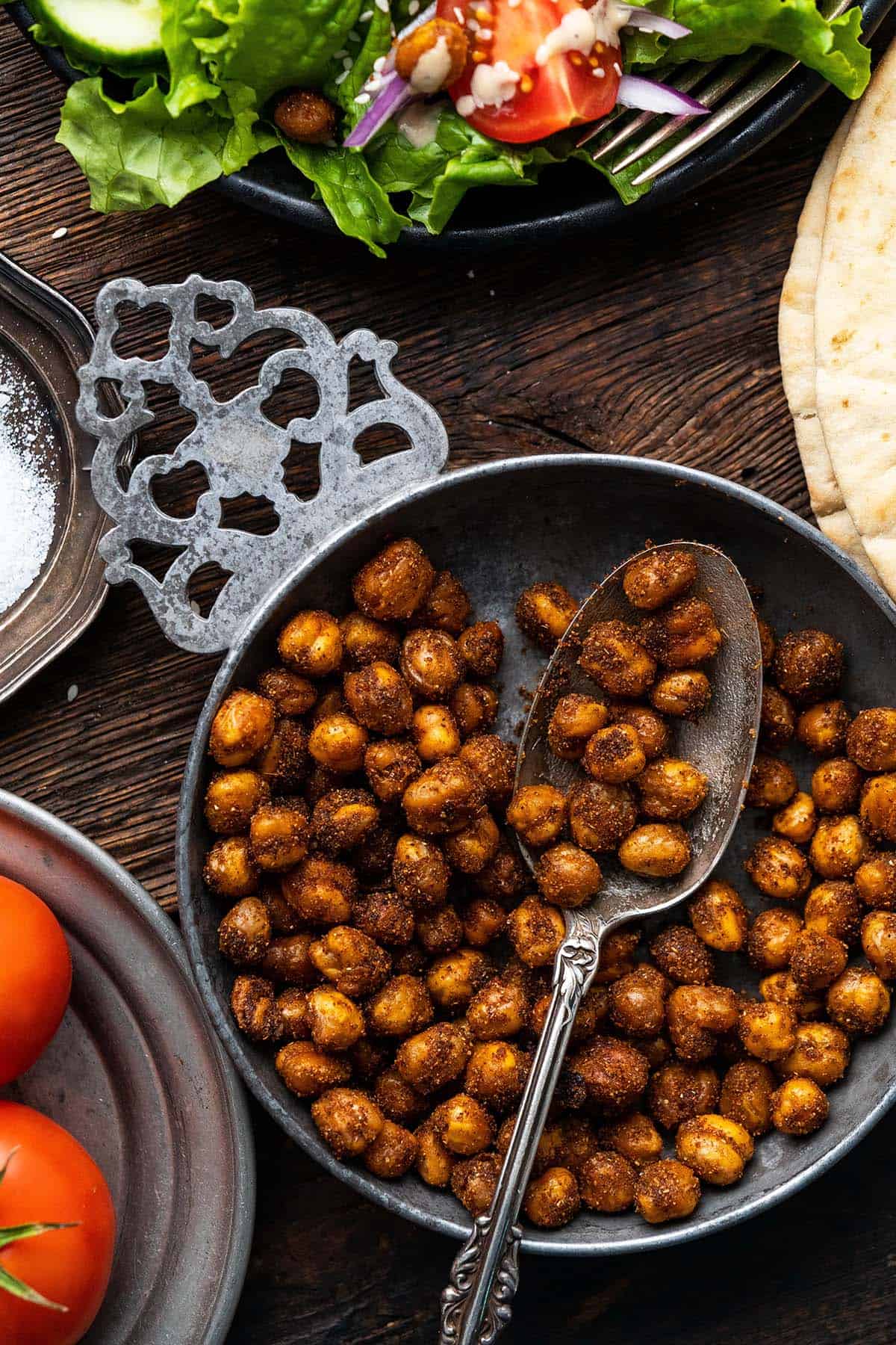 close up top view of healthy roasted chickpeas in middle eastern silver bowl