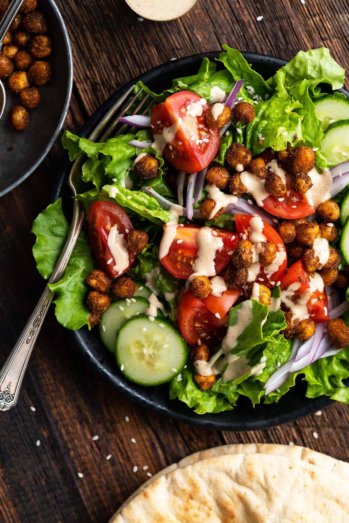 close up top view of roasted chickpea salad with tahini dressing