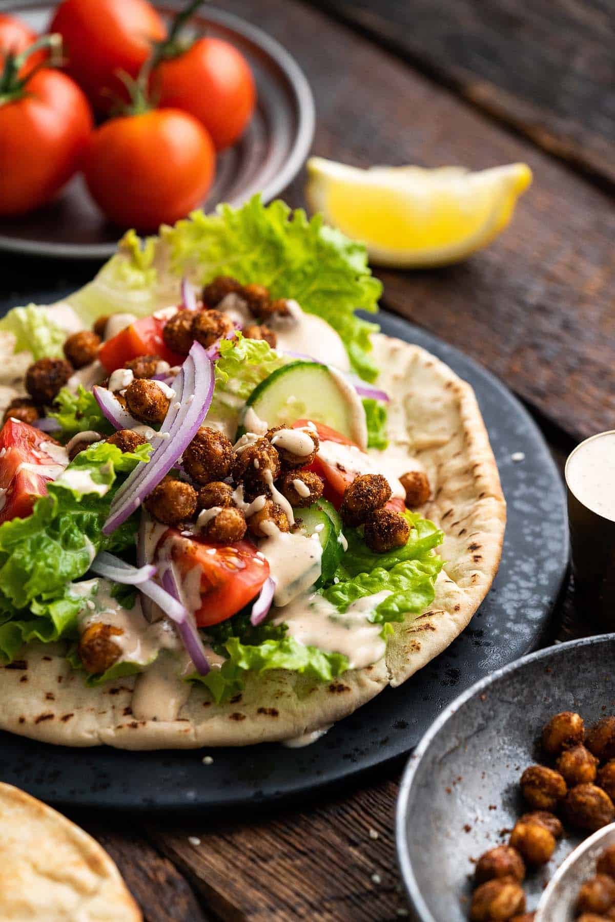 roasted chickpeas and vegetable pita sandwich with tahini dressing