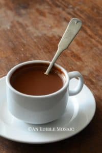 Drinking Chocolate (French Hot Chocolate) in White Cup with White Saucer on Wooden Table