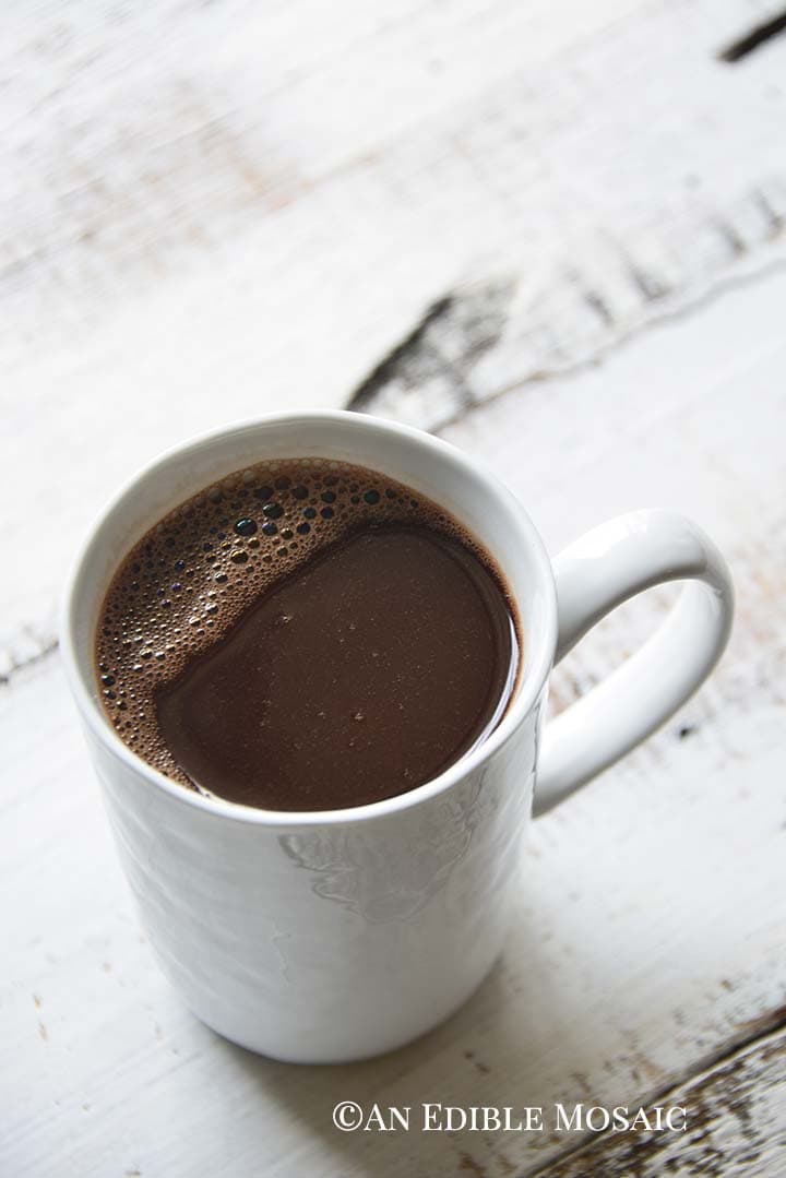 White Mug of French Hot Chocolate on Rustic White Wood Table