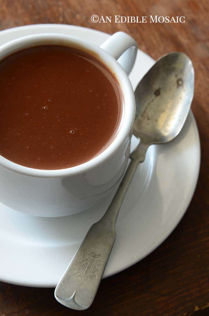 Close Up of Chocolat Chaud in White Cup on Dark Wooden Table