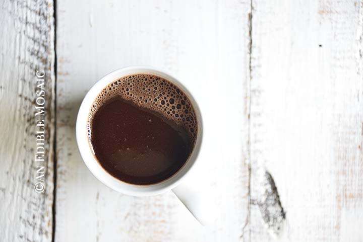 Close Up Overhead View of Mug of Drinking Chocolate on White Wooden Farmhouse Table