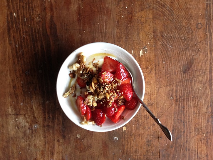 Greek yogurt topped with local organic strawberries, walnuts, honey, and a sprinkling of homemade granola.