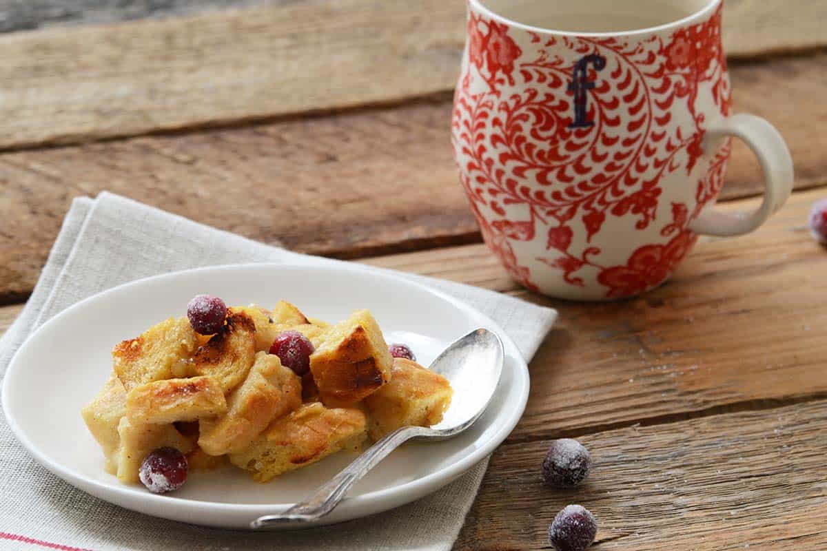 orange and nutmeg brown sugar bread pudding serving on white plate