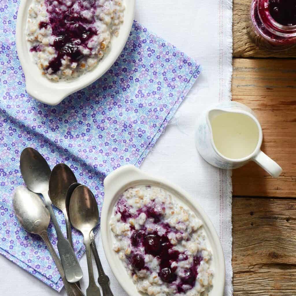 creamy wheat berry porridge with gingered blueberry topping featured image