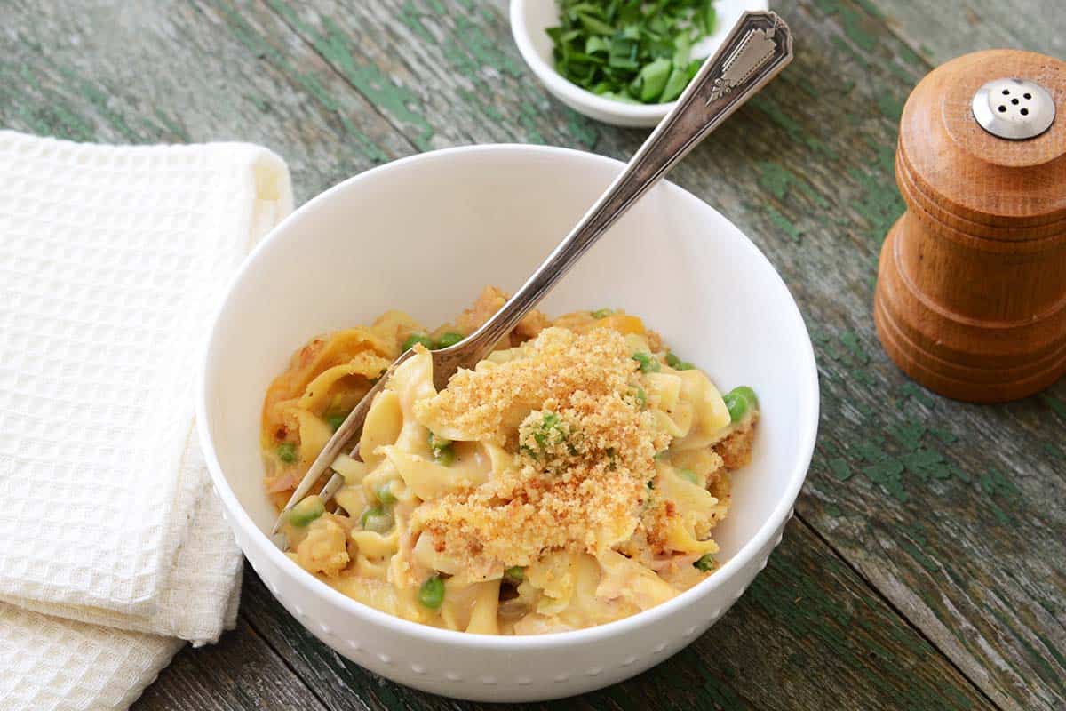 dish of easy tuna casserole on rustic green wooden table