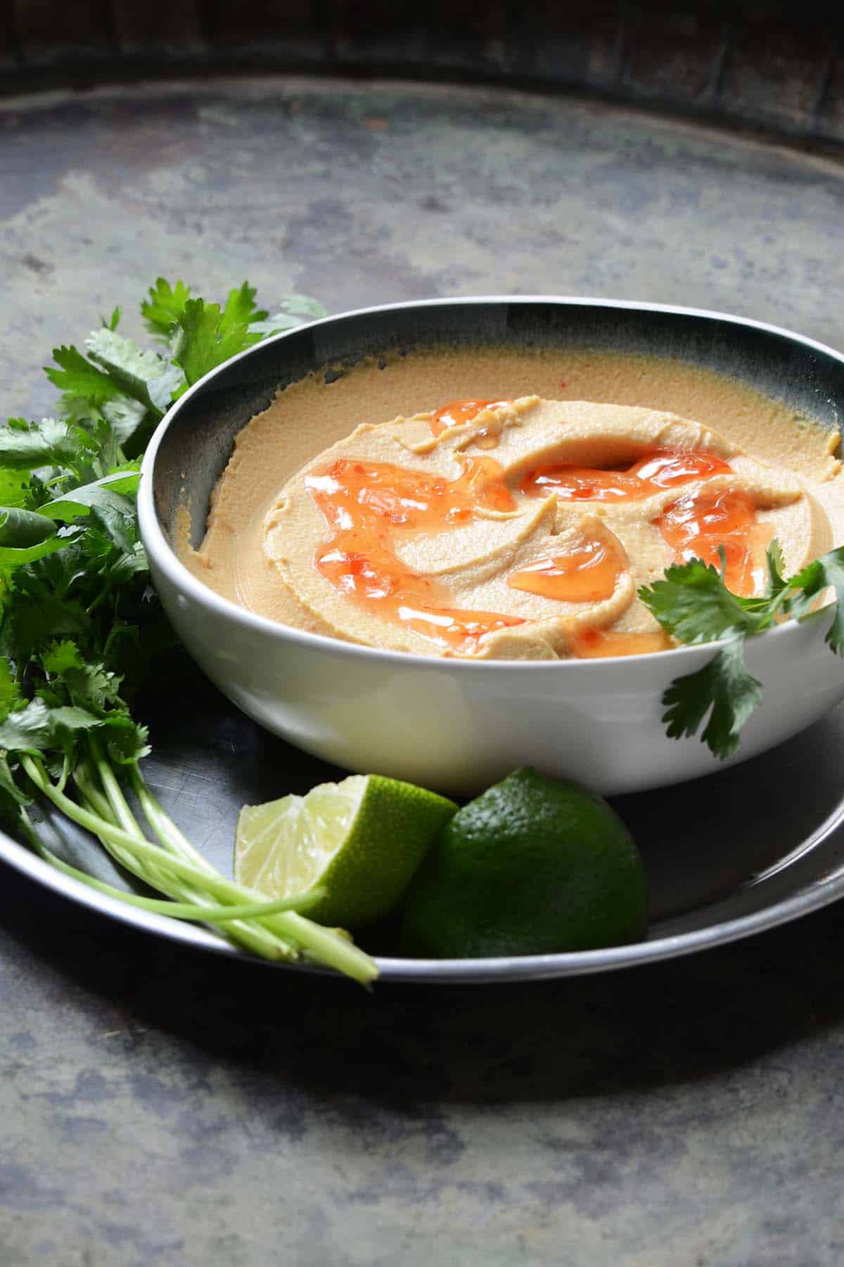 front view of thai curry hummus in serving bowl