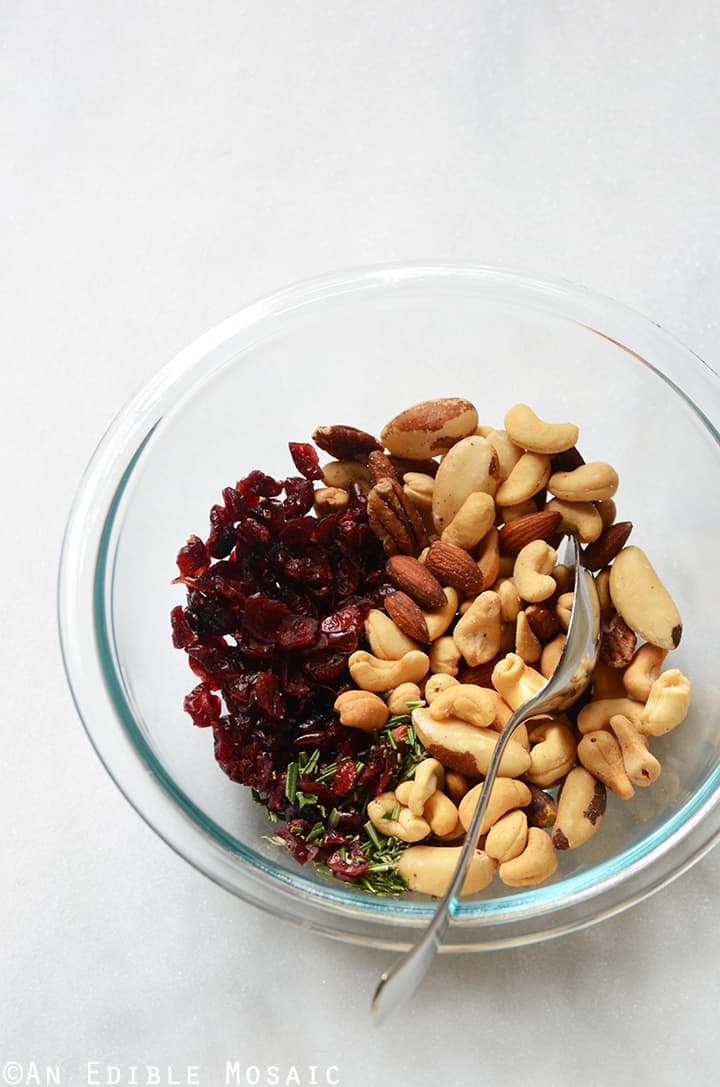 Festive Vanilla Bean Mixed Nuts with Rosemary and Cranberries In Mixing Bowl