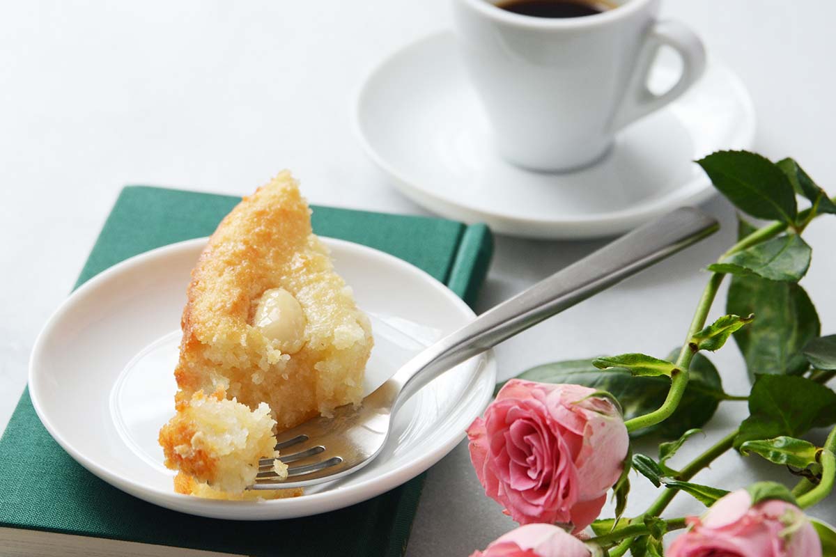 front view of cake slice on plate partially eaten with fork