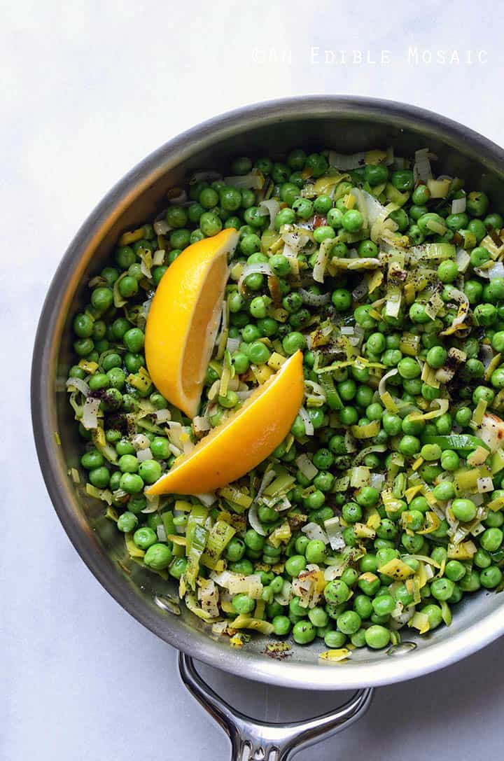 Sautéed Leeks with Sweet Green Peas, Sumac, and Honey in Skillet