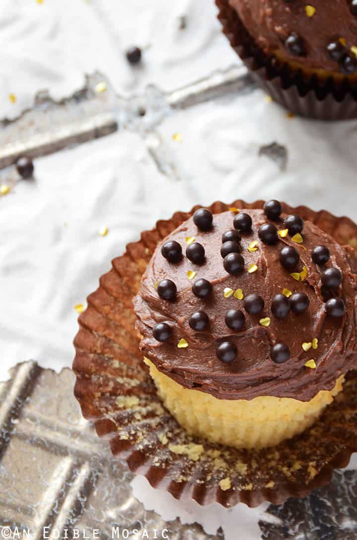 Yellow Cake Cupcakes with Fudgy Chocolate Buttercream for Two on Chipped White Tile Background