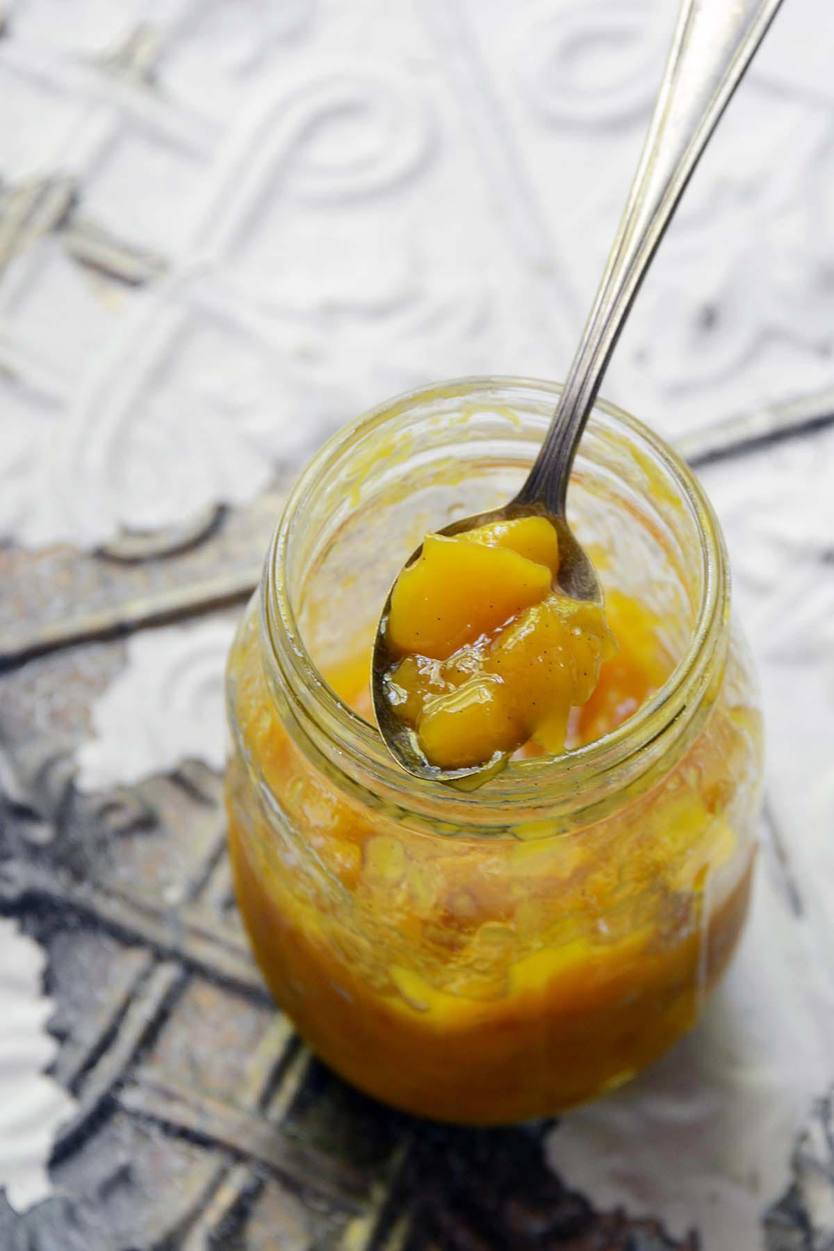 jar of mango preserves with vintage spoon