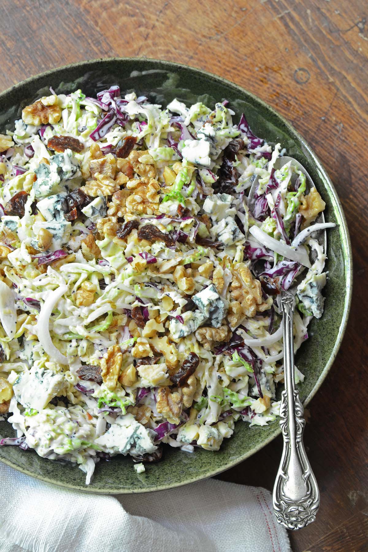 bowl of creamy blue cheese coleslaw salad with tart cherries and nuts