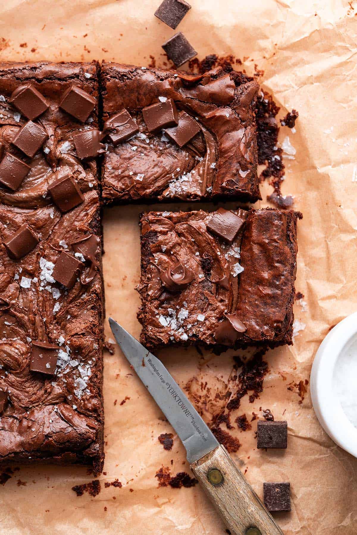 decadent nutella brownies on parchment paper topped with flaky sea salt