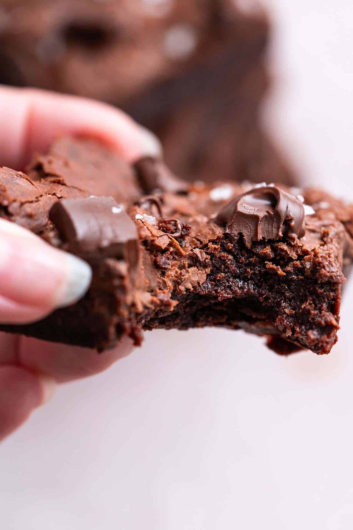 hand holding nutella brownie with bite taken out