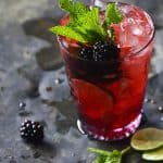 Blackberry Syrup, Mint, and Lime Spritzers on Metal Tray Front View
