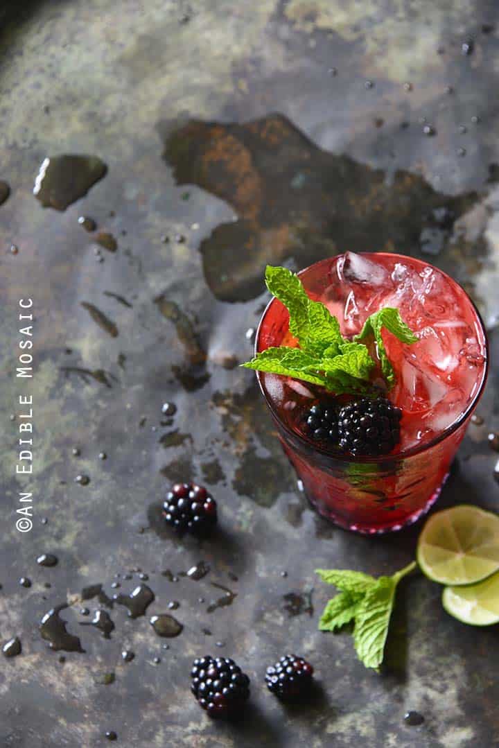 Blackberry Syrup, Mint, and Lime Spritzers on Metal Tray Top View Vertical Orientation