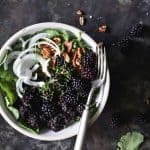 Vegan Herbed Black Rice, Black Lentils, and Black Quinoa Pilaf Salad Bowls with Blackberries on Weathered Metal Background Top View Vertical Orientation