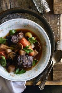 Braised Beef with Root Vegetables and Red Wine on Wooden Table Top View