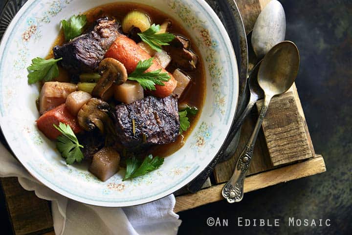 Braised Beef with Root Vegetables and Red Wine on Wooden Table Top View Horizontal Orientation