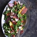 Kale Salad with Roasted Fingerling Potatoes, White Beans, and Warm Bacon Dressing Metal Background Top View Vertical Orientation
