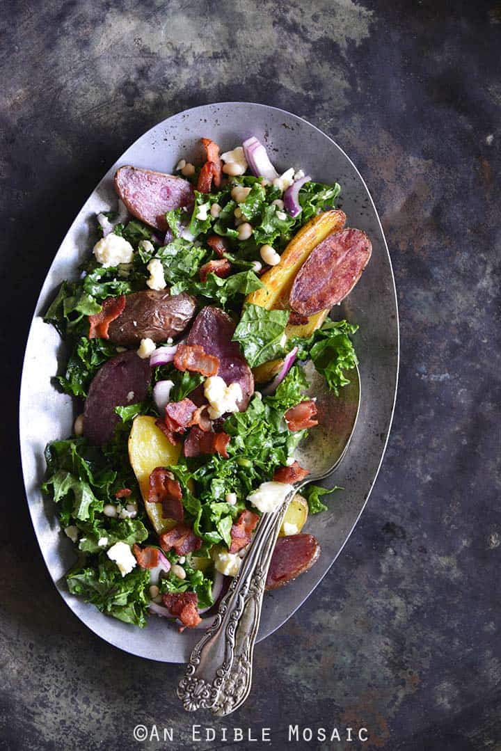 Kale Salad with Roasted Fingerling Potatoes, White Beans, and Warm Bacon Dressing Metal Background Top View Vertical Orientation