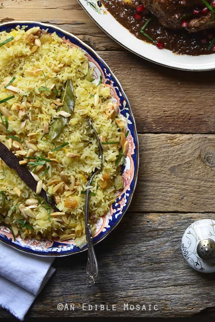 Orange and Toasted Almond Saffron Rice Pilaf with Golden Raisins on Wooden Table