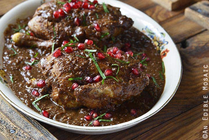 Persian Inspired Cornish Hens with Pomegranate Walnut Sauce Front View on Wooden Table Horizontal Orientation
