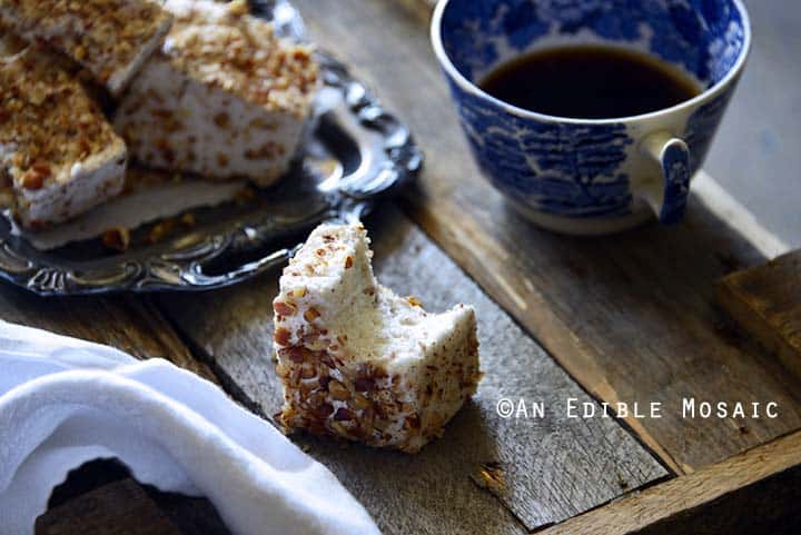 Vanilla Bean and Maple Toasted Pecan Marshmallows on Metal Tray on Wooden Table with Bite