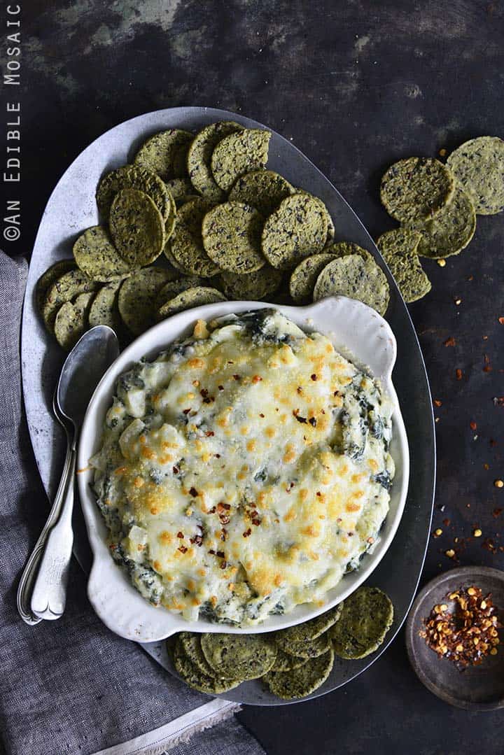 Spread of Warm Cheesy Garlic and Kale Dip with RW Garcia 3 Seed Kale Crackers